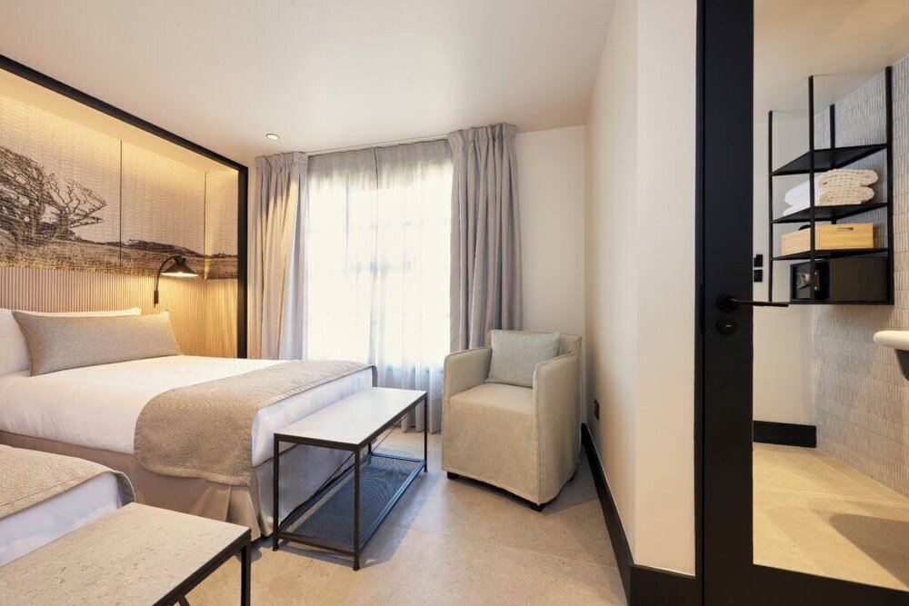 Modern hotel room with a large bed and a desk