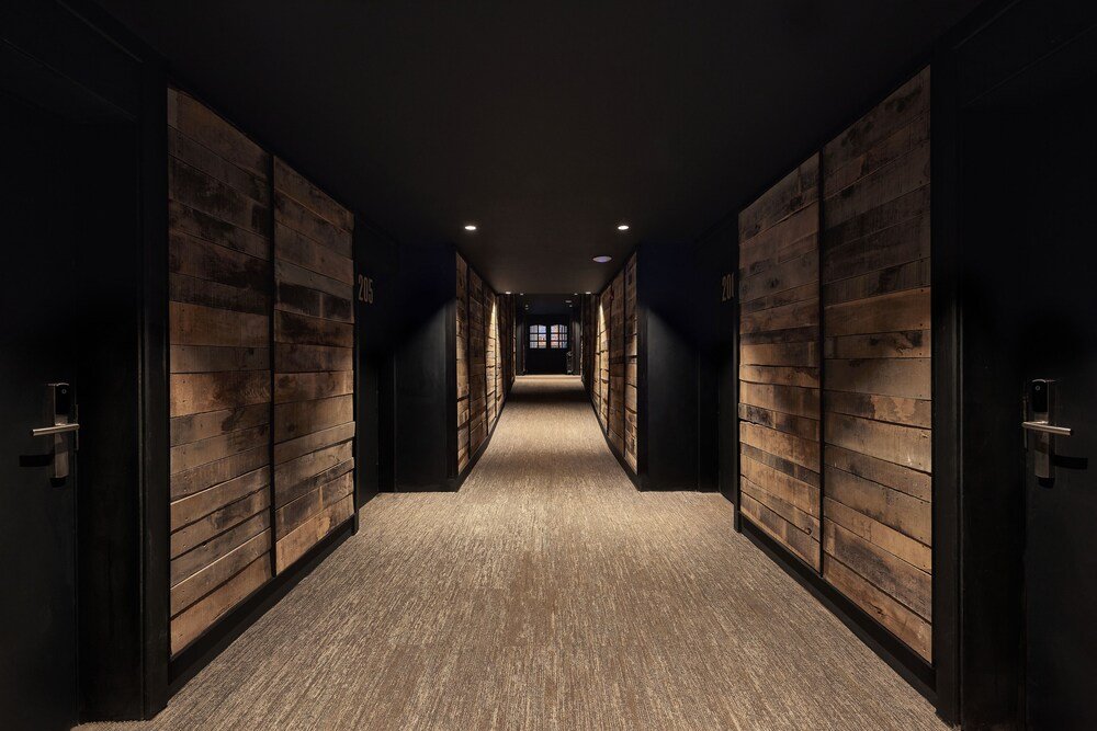 Narrow hallway with wooden paneling inside the hotel