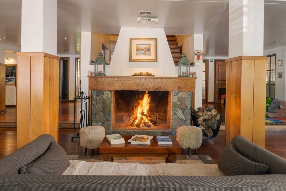 Living room with a fireplace and wooden furniture at the hotel