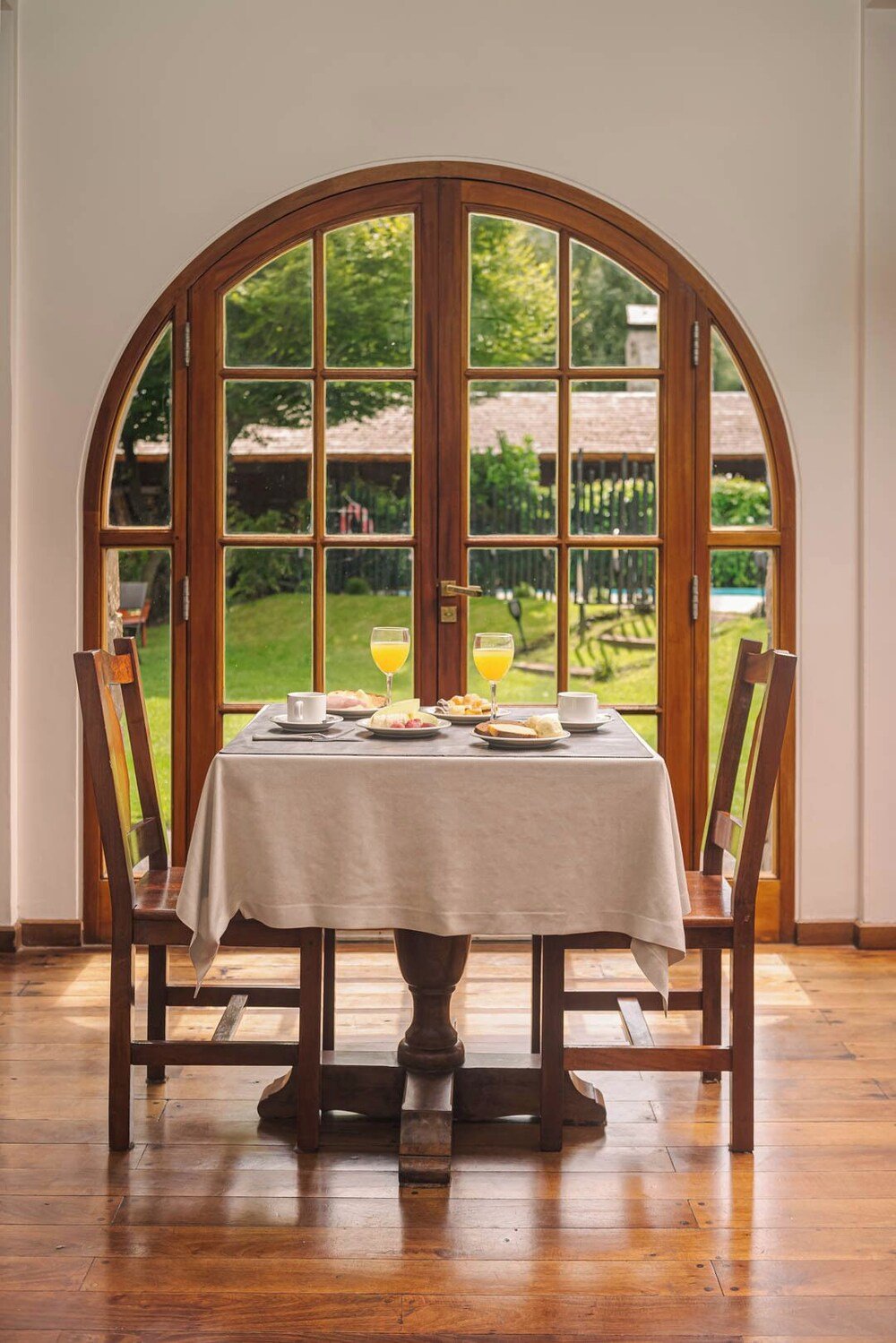 Dining table with a white tablecloth set for breakfast