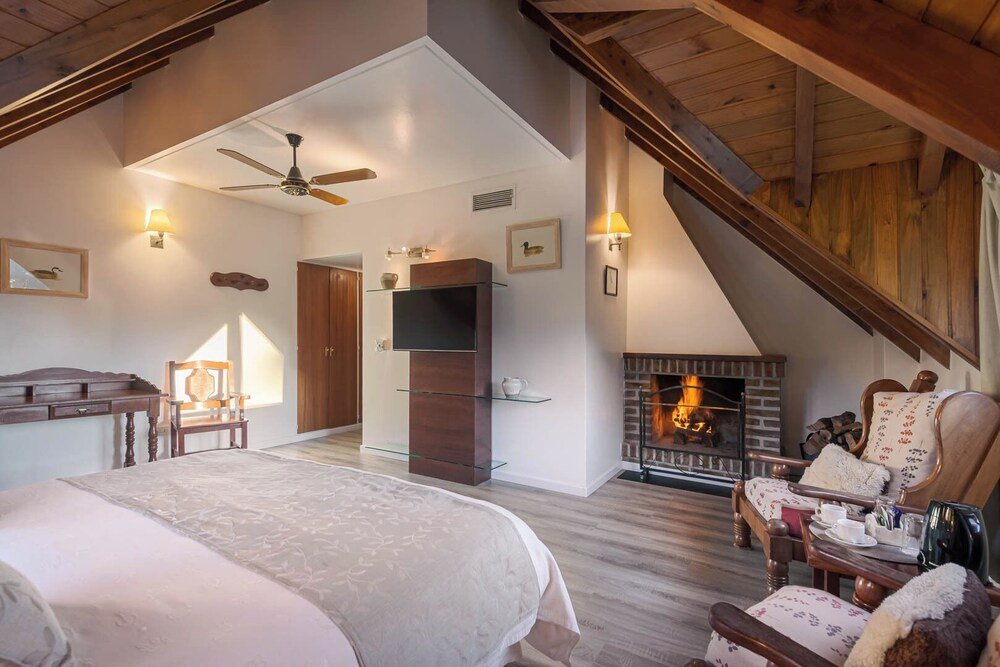 Spacious bedroom with a large bed and traditional furnishings