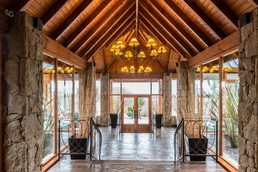 Spacious lobby with a high ceiling and stone walls