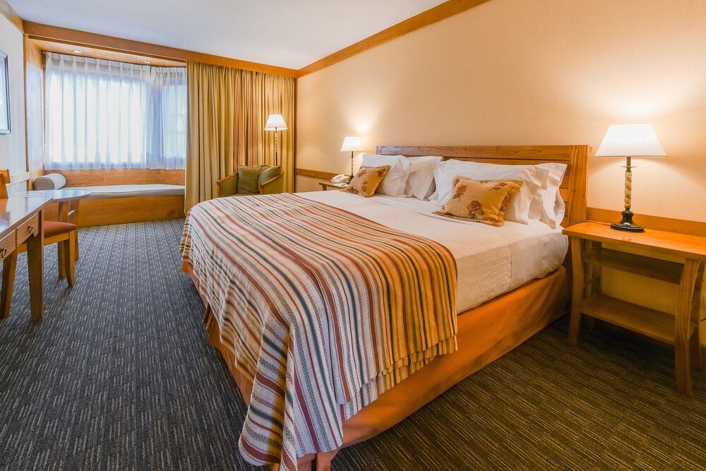 Hotel room with a large bed and desk
