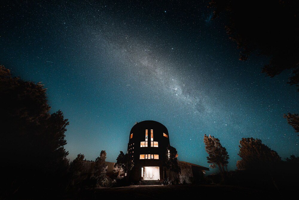 Dome-roofed building with many windows under a starry night sky
