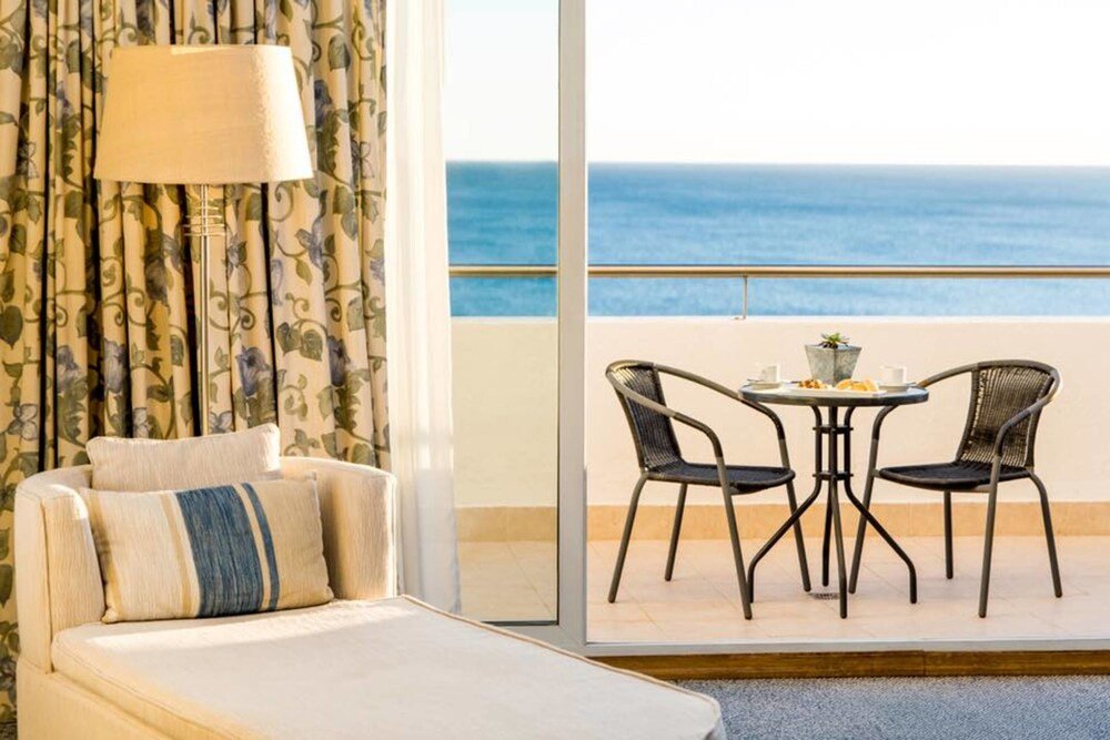 Hotel room with a bed and a small table
