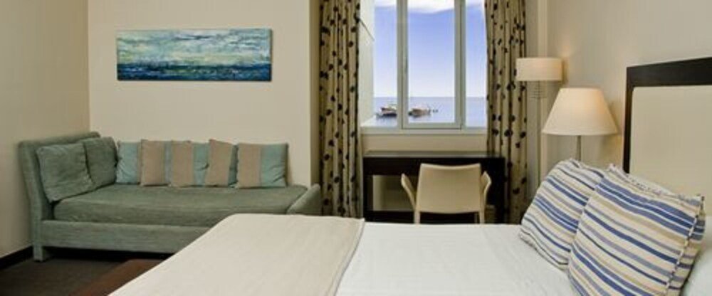 Hotel room with a bed and a sofa