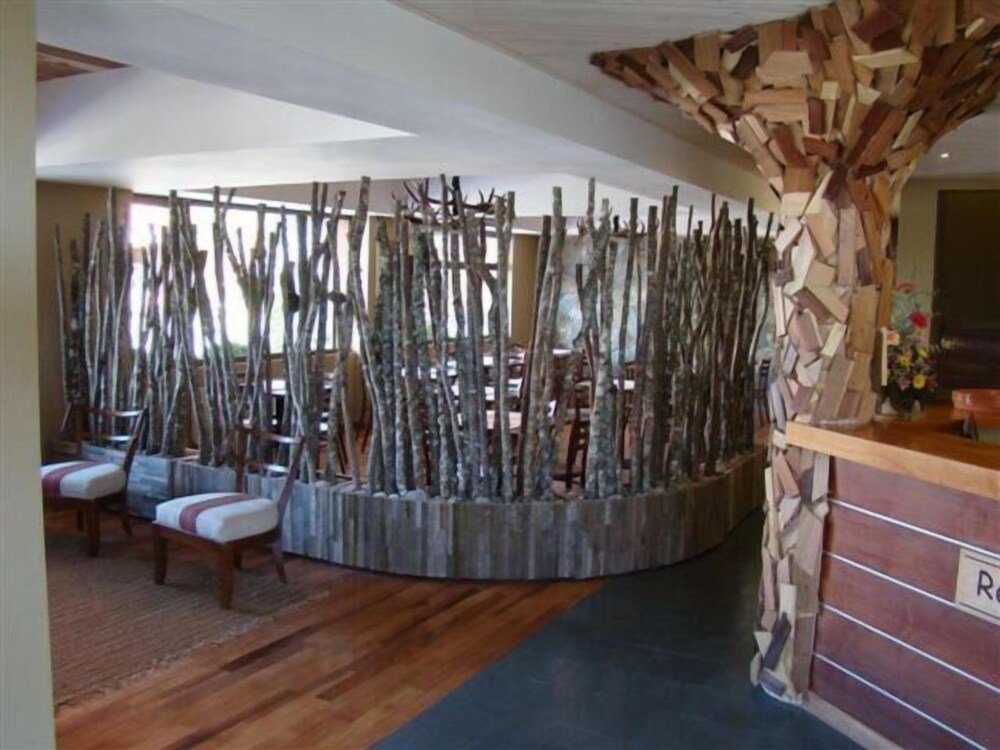 Reception area with wooden desk, seating and vertical wooden slats