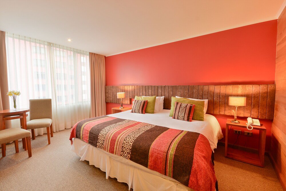 Twin room with two beds, desk and large curtained window