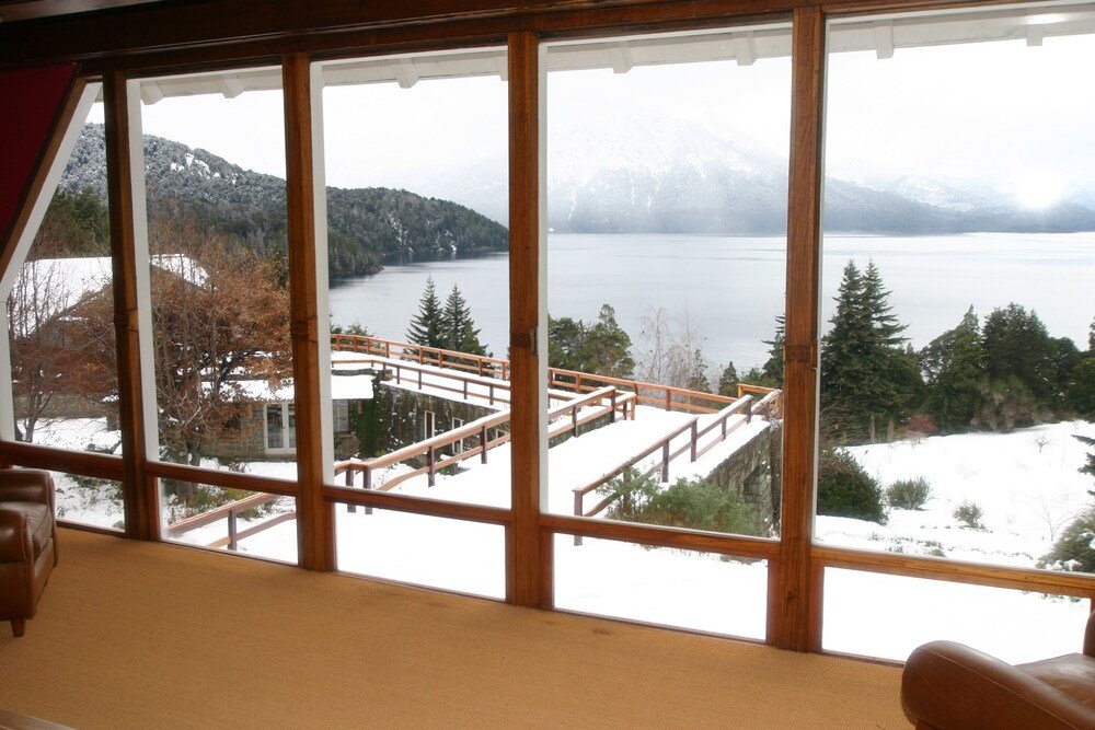 Hotel room with large windows opening onto a view