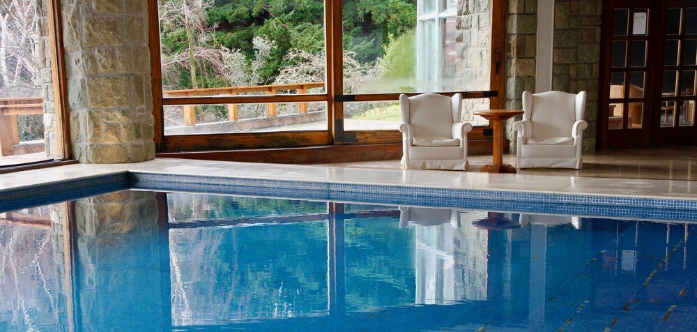 Indoor pool area with stone walls at Hotel Tunquelén