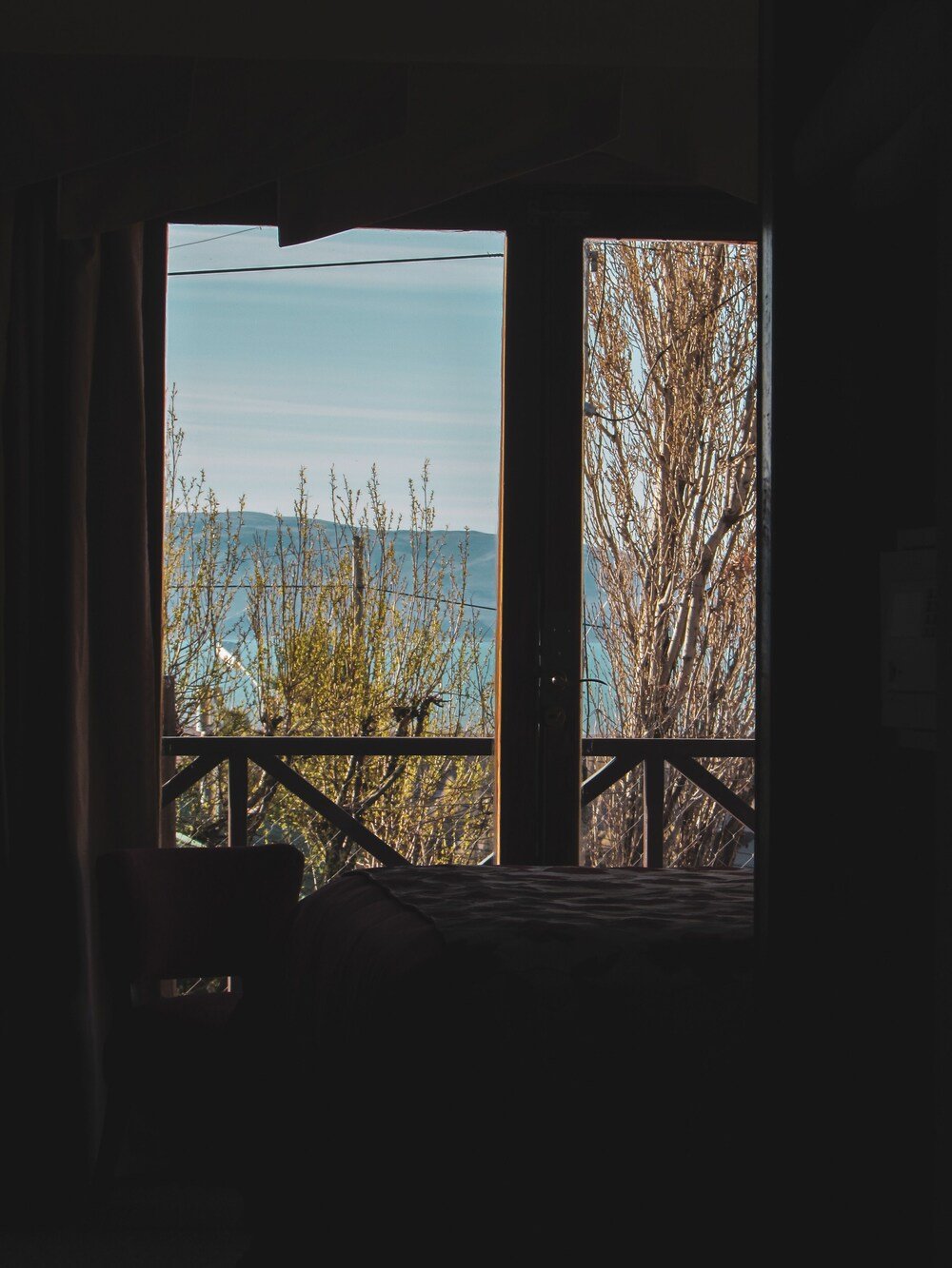 Room with a view of trees and mountains