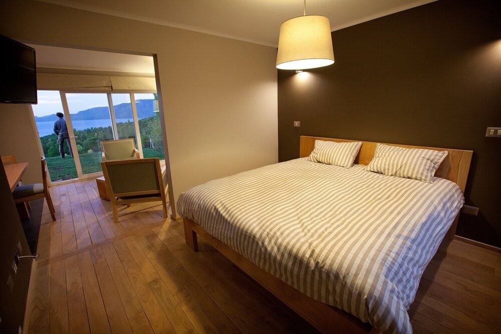 Guest room with bed and balcony access at the lodge