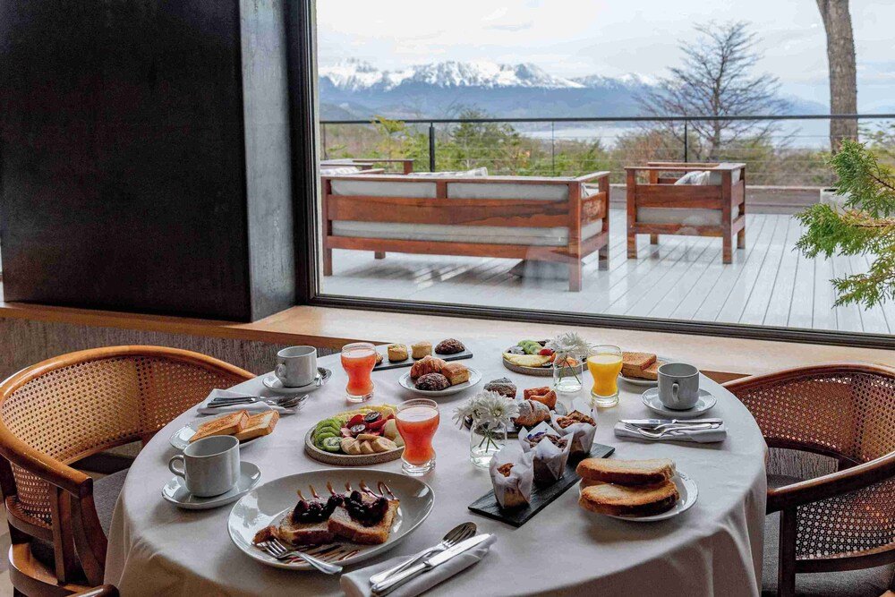 Breakfast table with various dishes and a view