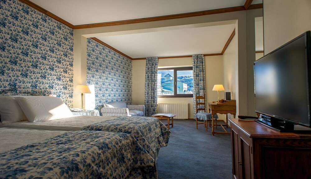 Hotel room with two beds and a television