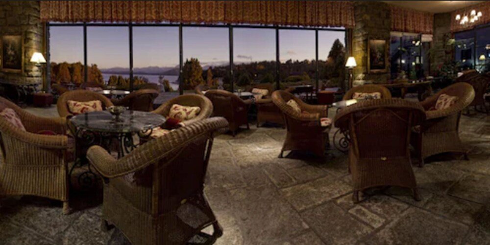 Cozy lounge area with wicker furniture and a stone floor