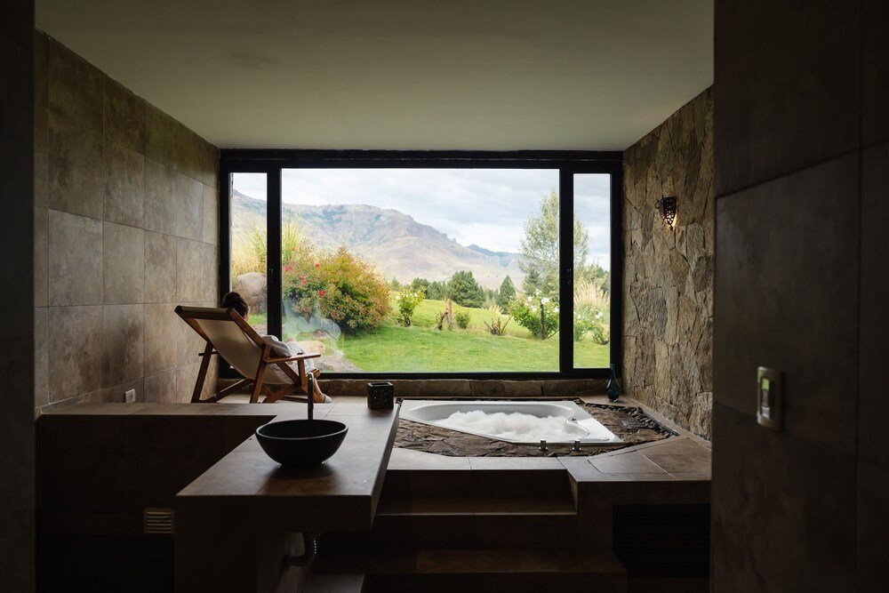 Modern bathroom with a large window at the resort suite