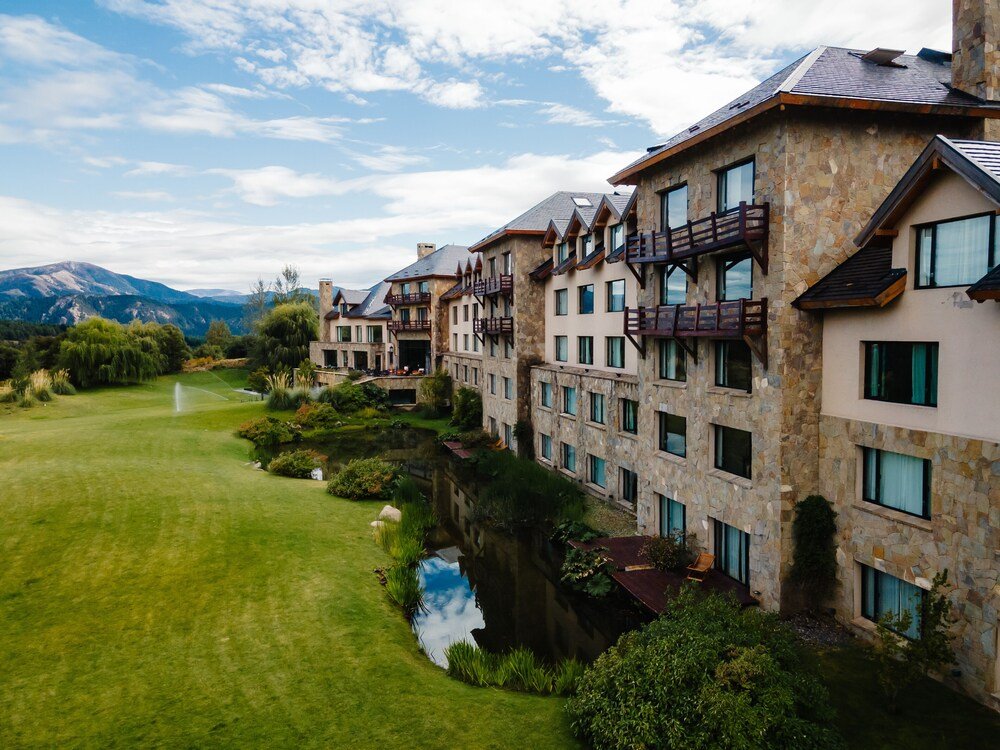 Multi-storey hotel building with a stone facade near the mountain