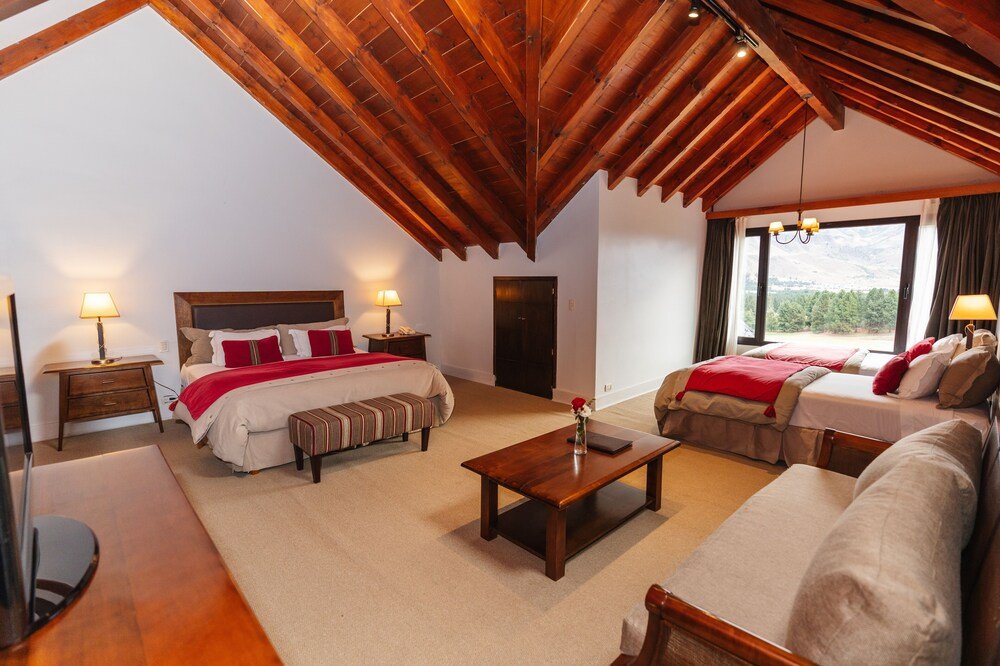 Spacious guest room with a wooden ceiling at the resort