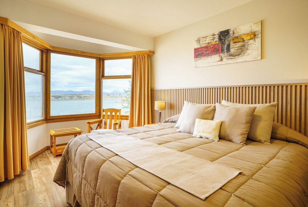 Bedroom with a large bed and a view of the sea