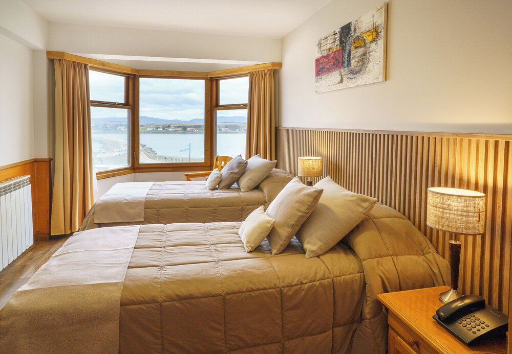 Hotel room with two beds and a view of the sea