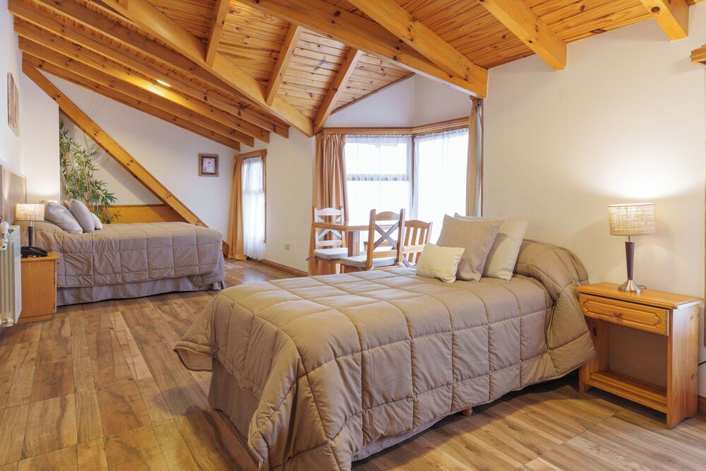 Bedroom with two beds and wooden flooring