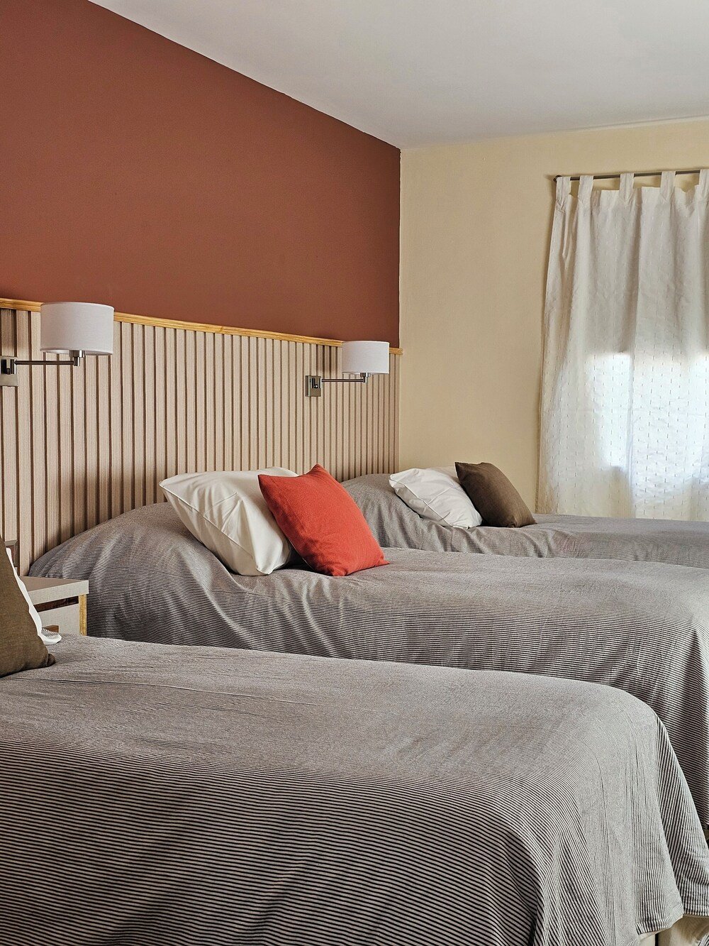 Hotel room with two beds and striped bedding