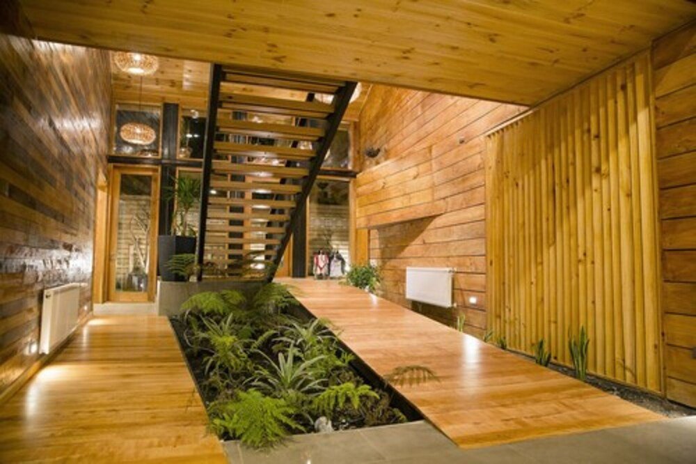 Modern interior with wooden walls, a central walkway and staircase