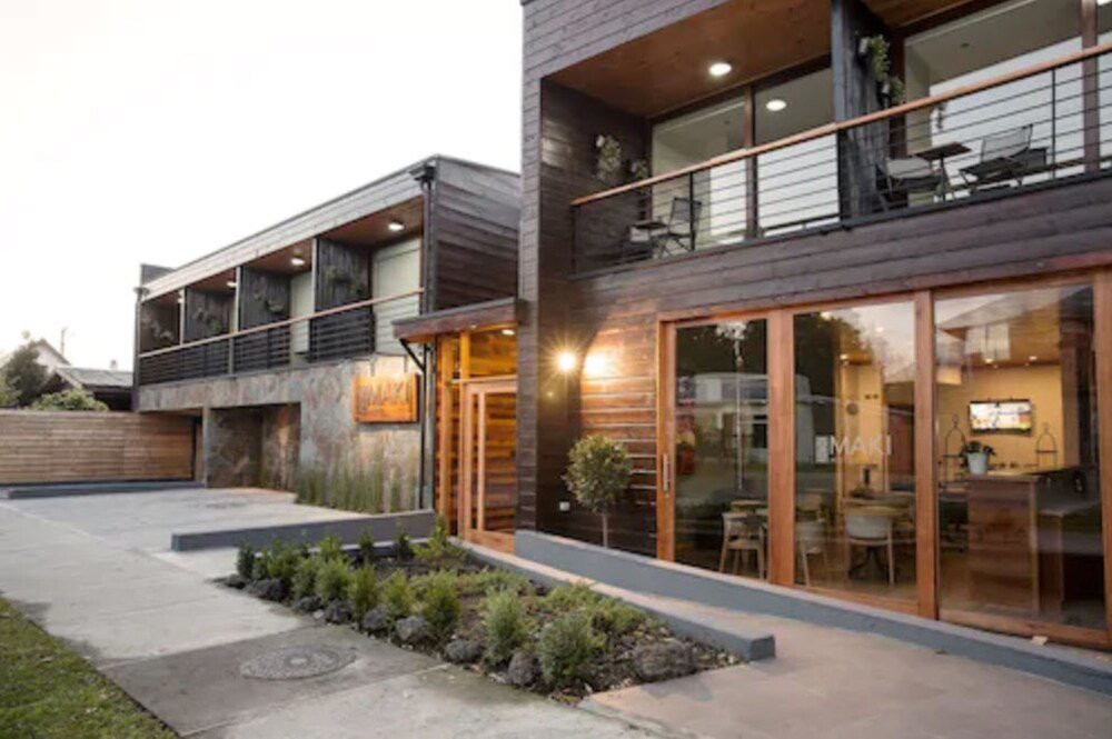 Modern two-story building with large windows and a balcony