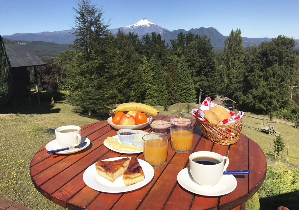 Wooden table with breakfast items and a mountain view