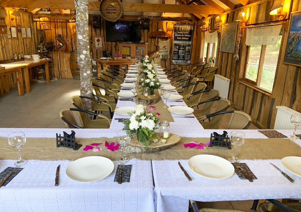 Long dining table set for a meal in a wooden interior