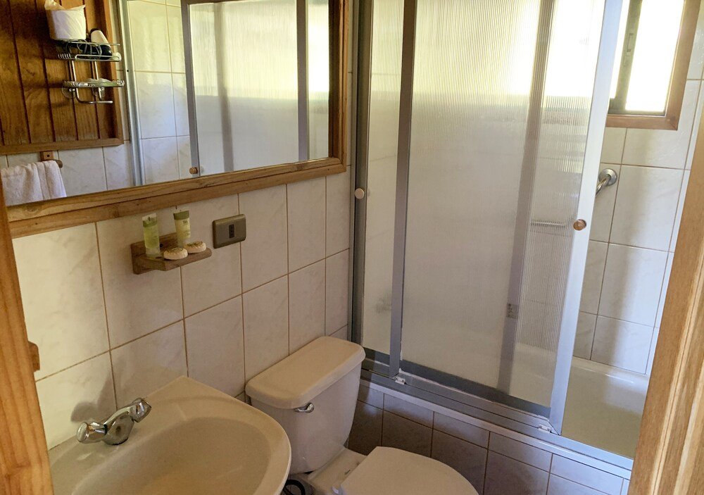 Plain bathroom with a toilet, sink and shower