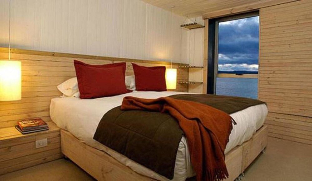 Dormitorio con cama y almohadas en Noi Indigo Patagonia