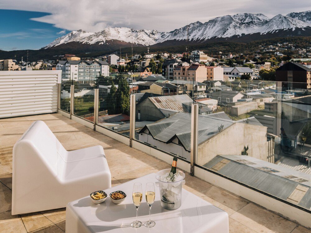 Rooftop terrace with a table set for two and champagne
