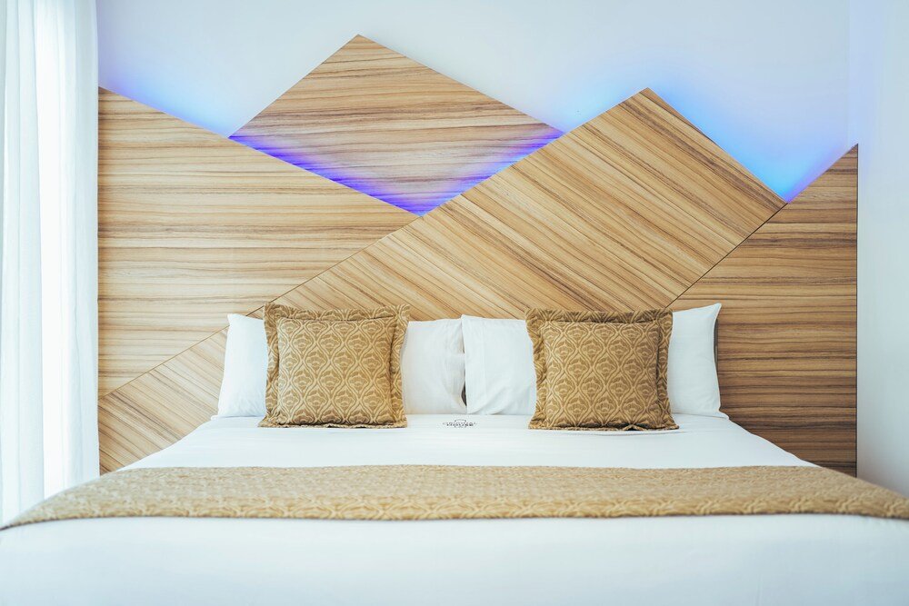 Hotel room with a wooden headboard and white bedding