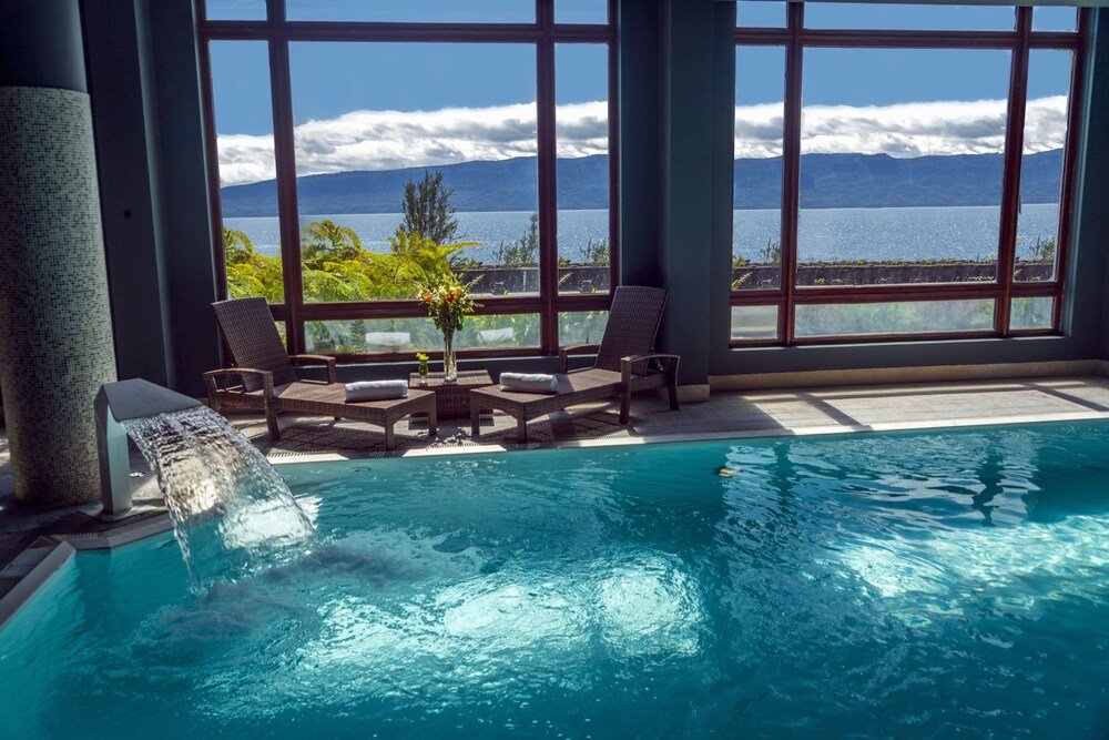 Pool area with a waterfall feature at Park Lake Luxury Hotel