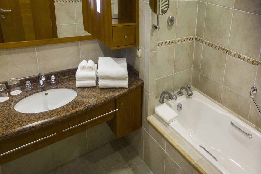 Bathroom with a granite counter at Park Lake Luxury Hotel