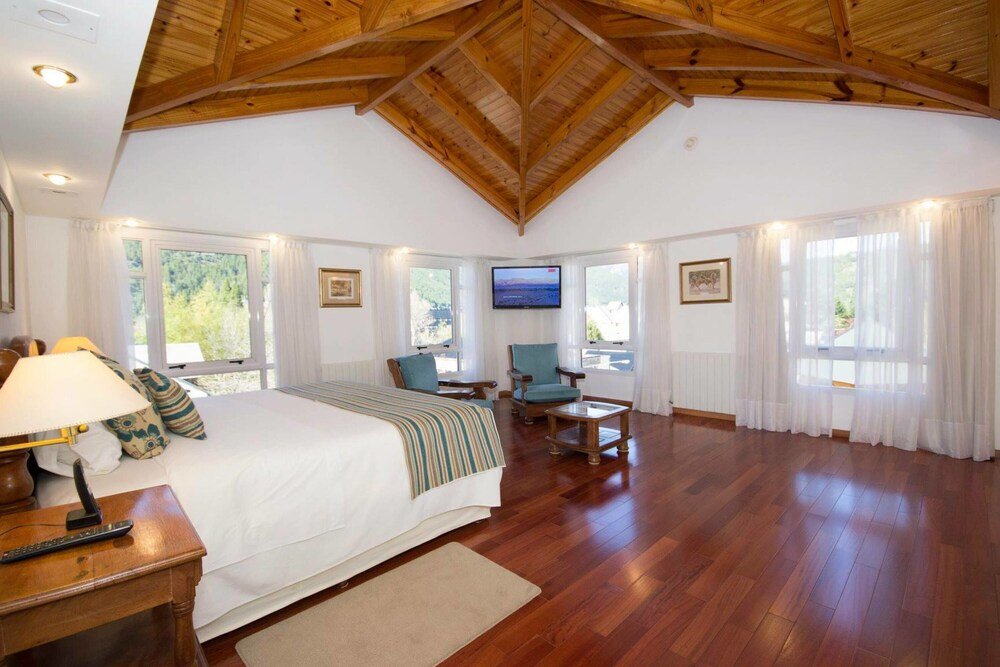 Spacious bedroom with a large bed and warm lighting
