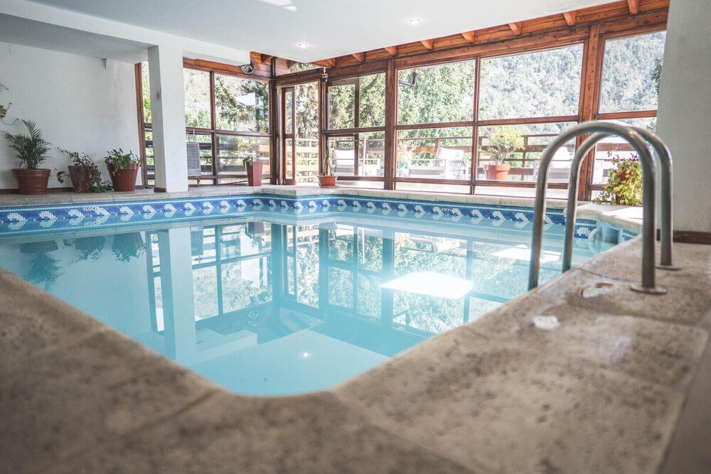 Indoor swimming pool with a tiled floor at the hotel
