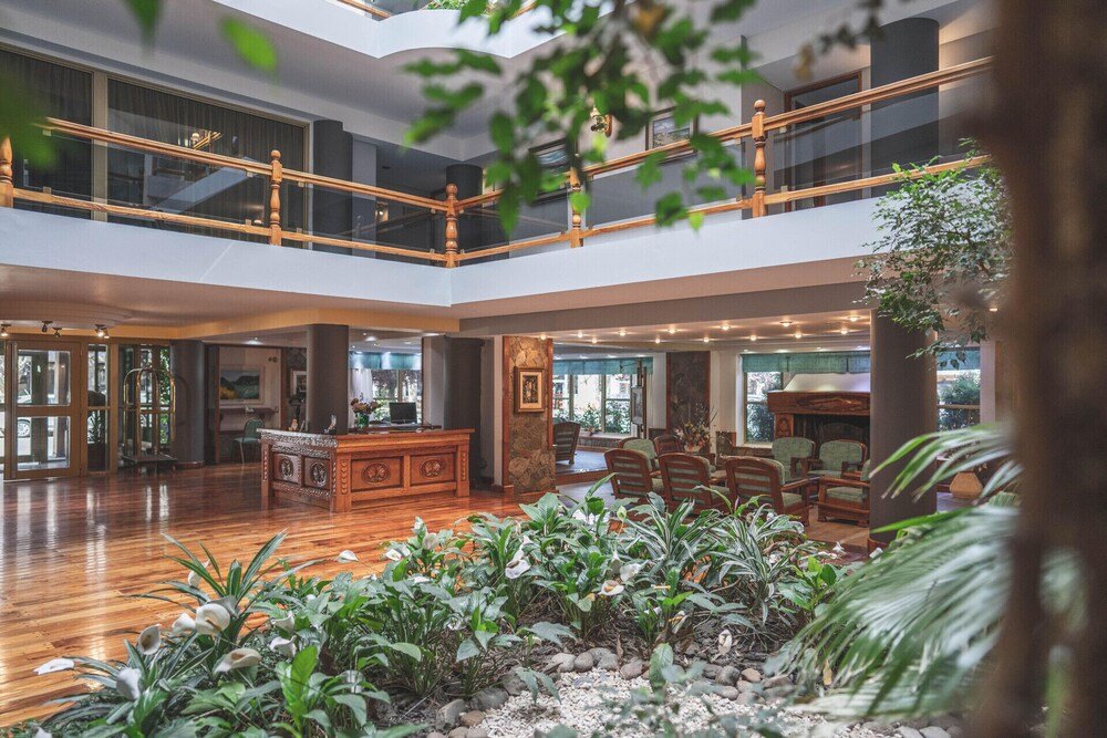 Spacious lobby with a wooden reception desk at the hotel