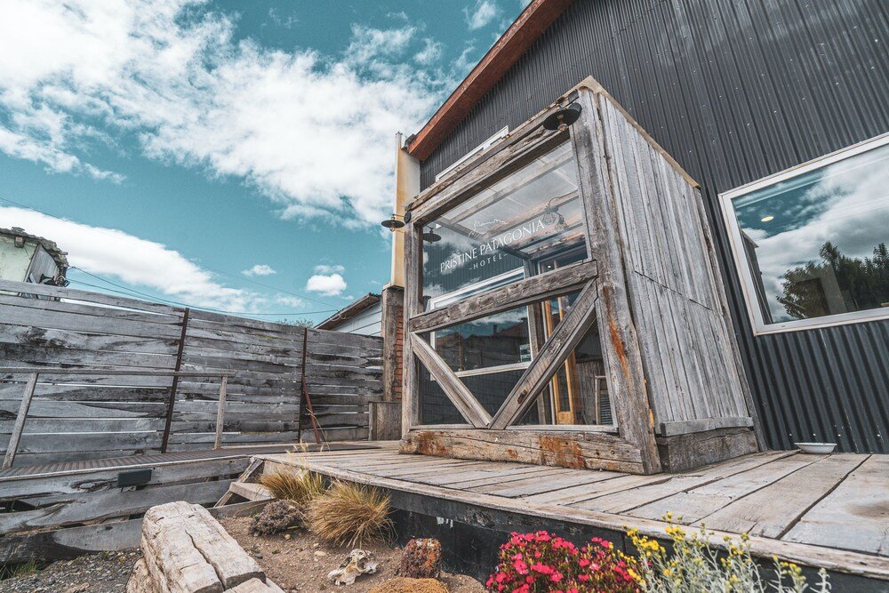 Rustic wooden building with a large window and a wooden deck