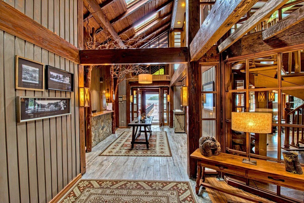 Interior de madera con chimenea central en el lodge