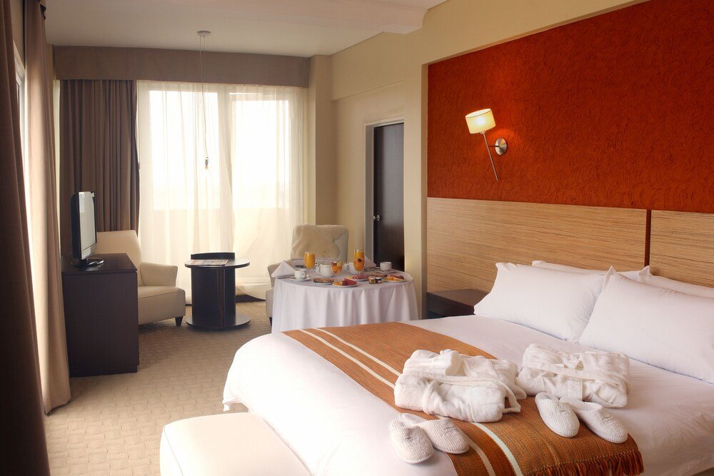 Hotel room with a large bed and warm lighting