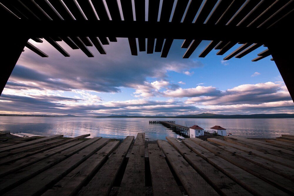 Wooden pier extending into the calm waters of the fjord