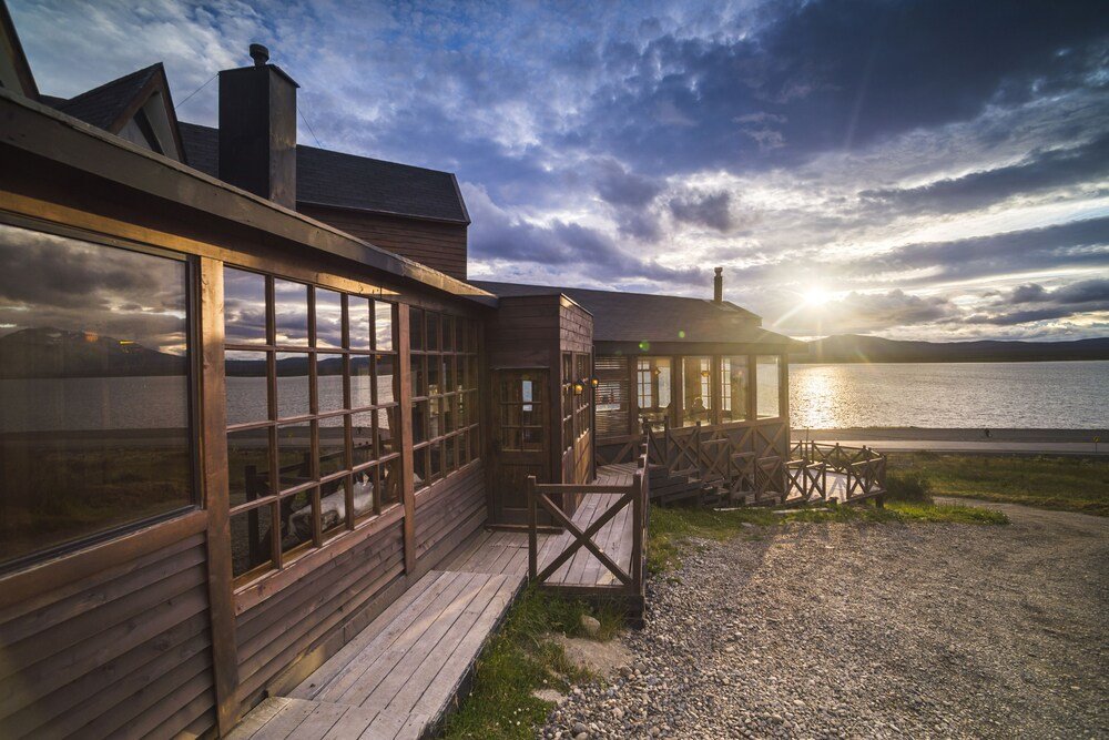 Wooden building with large windows overlooking the water
