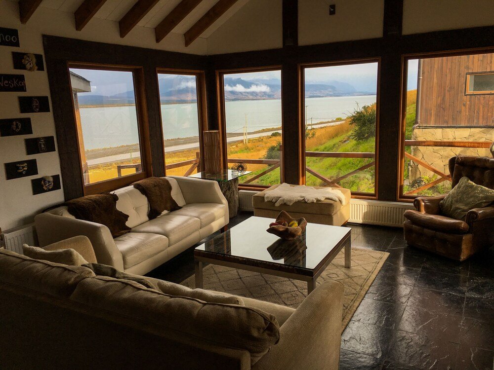 Spacious living room with a large window over a scenic lake